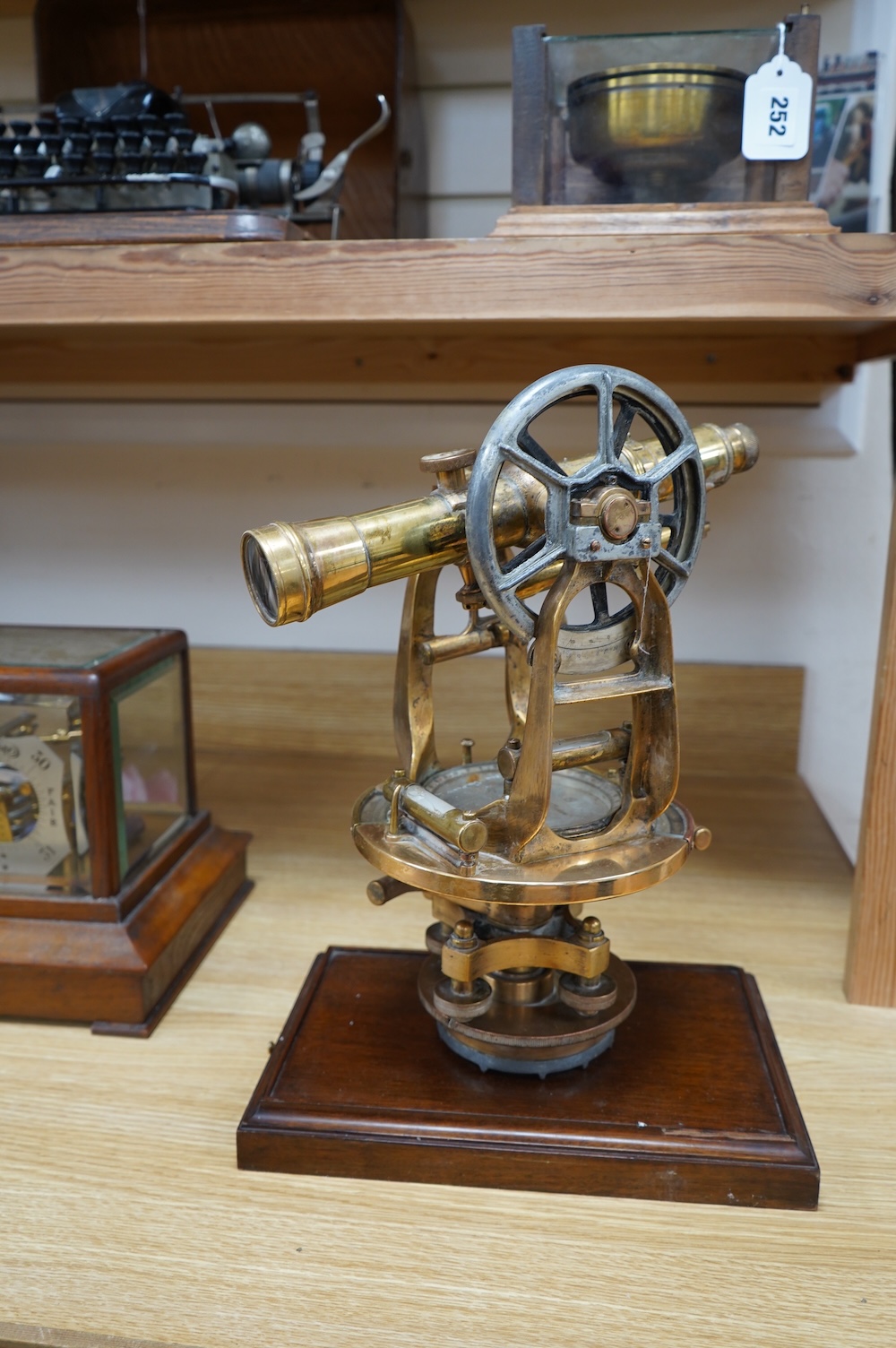 An early 20th century American brass theodolite by Keuffel and Esser Co. mounted on a mahogany base, 39.5cm high. Condition - fair to good.